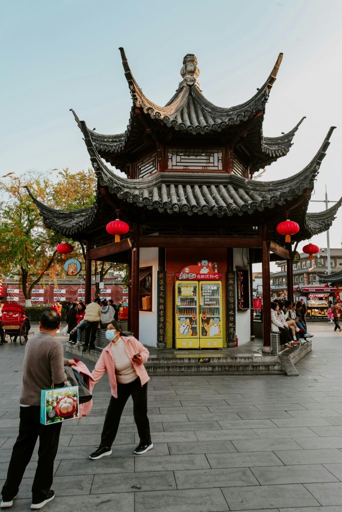 A lively street view near the Nanjing Confucius Temple showcasing traditional architecture and vibrant urban life.