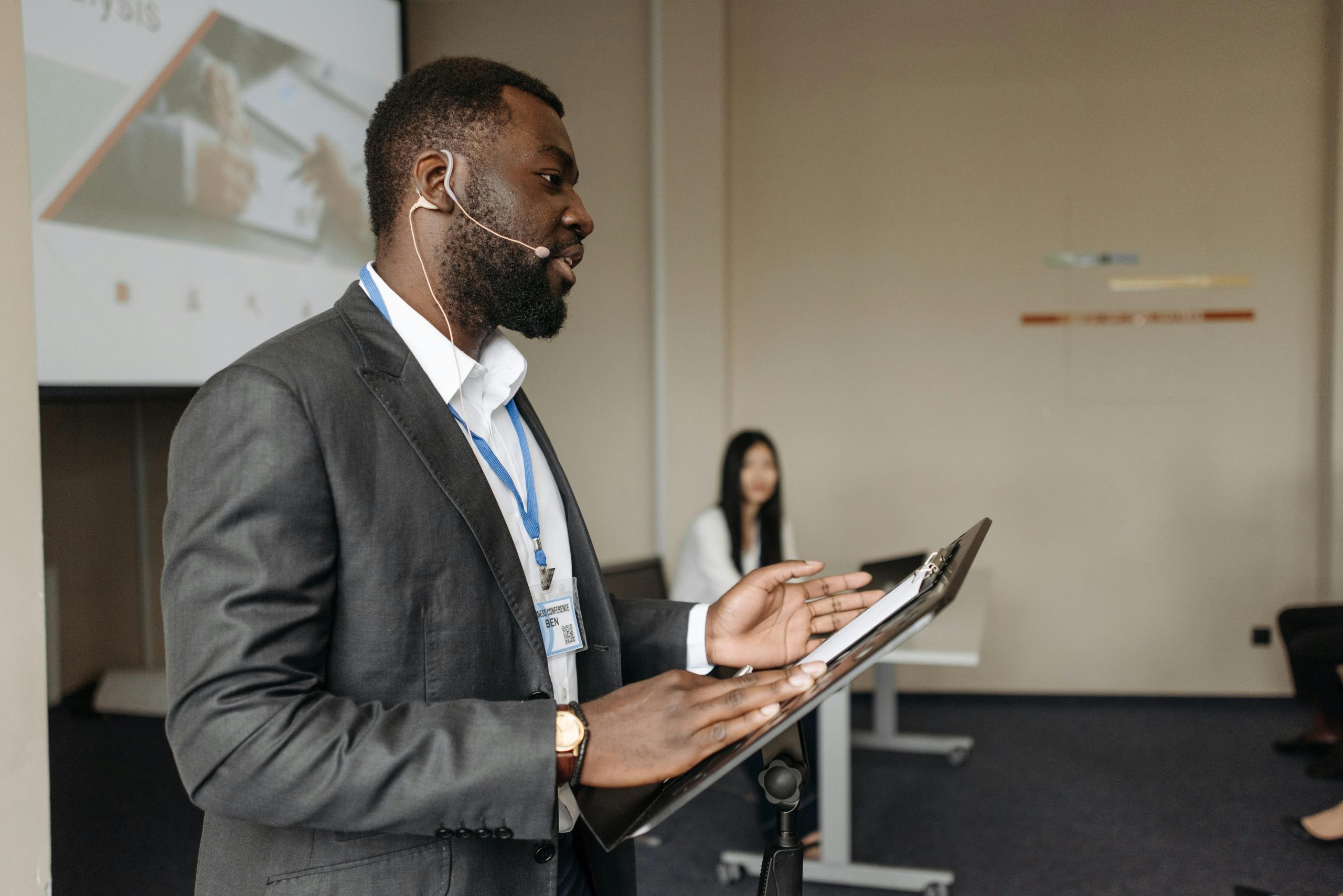 Professional speaker at a business conference presenting with confidence.